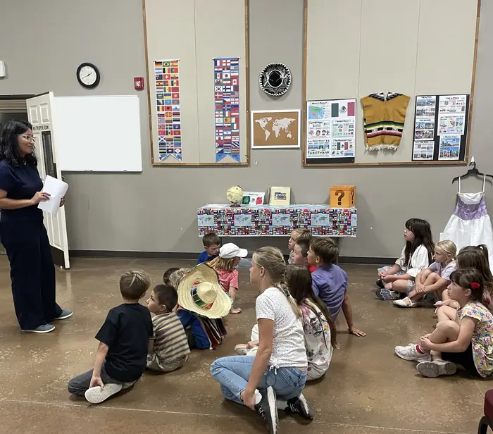 Cornerstone students sitting on the floor for a Missionaries in Training lesson about Mexico